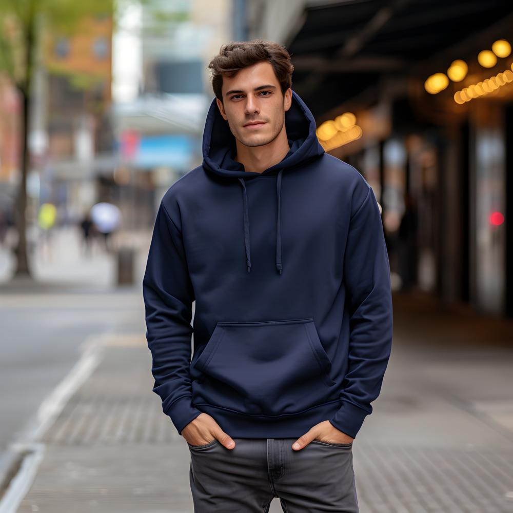 Person standing in an urban setting wearing a hoodie